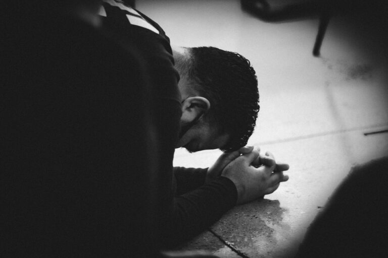 Inmate Praying on Floor.